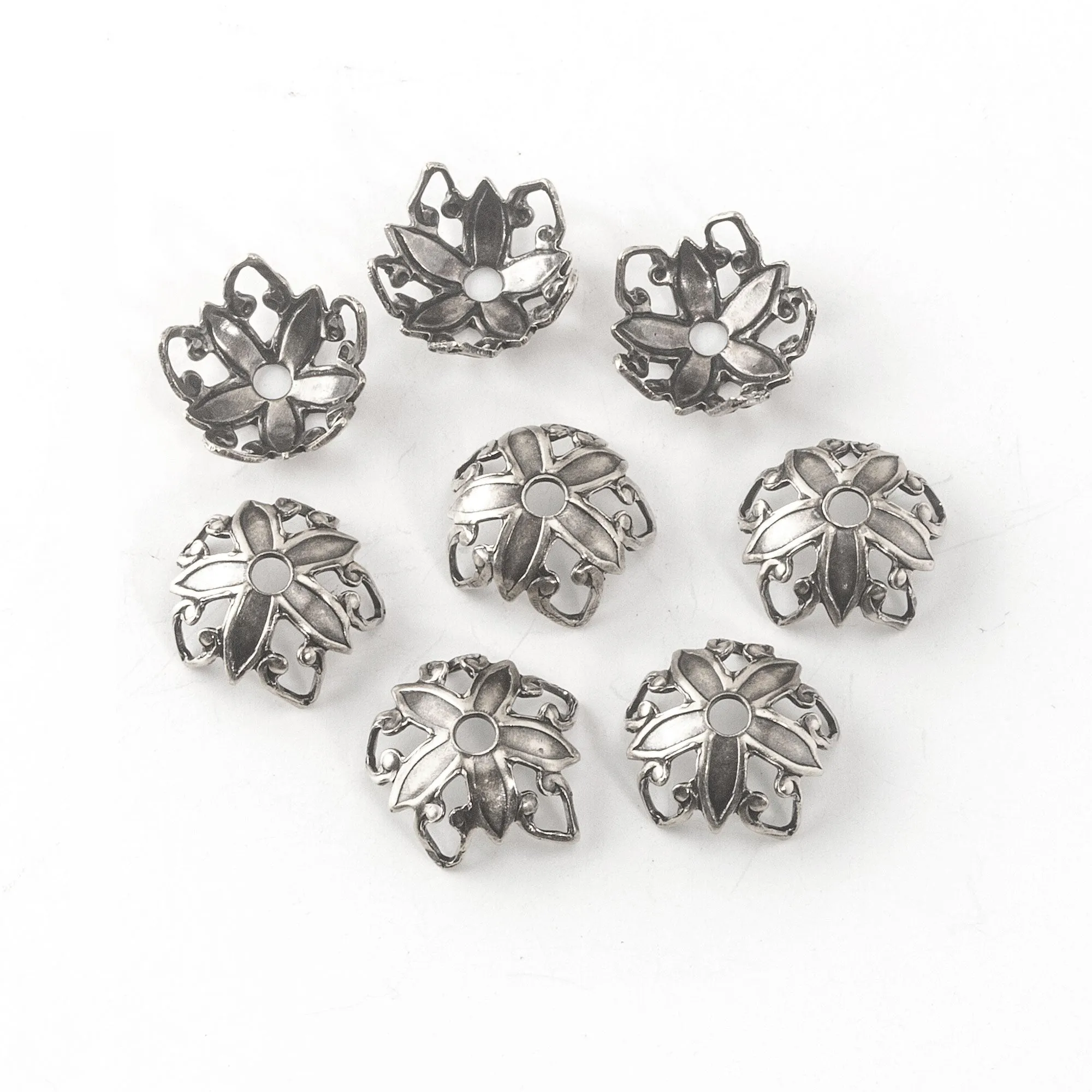 Stamped sterling silver plated brass bead cap in a floral design. 9x4mm. Package of 12. b9-2376s